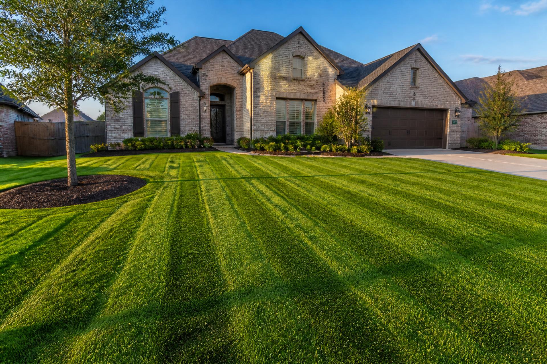 Freshly mowed striped green lawn in front of a Texas suburban home